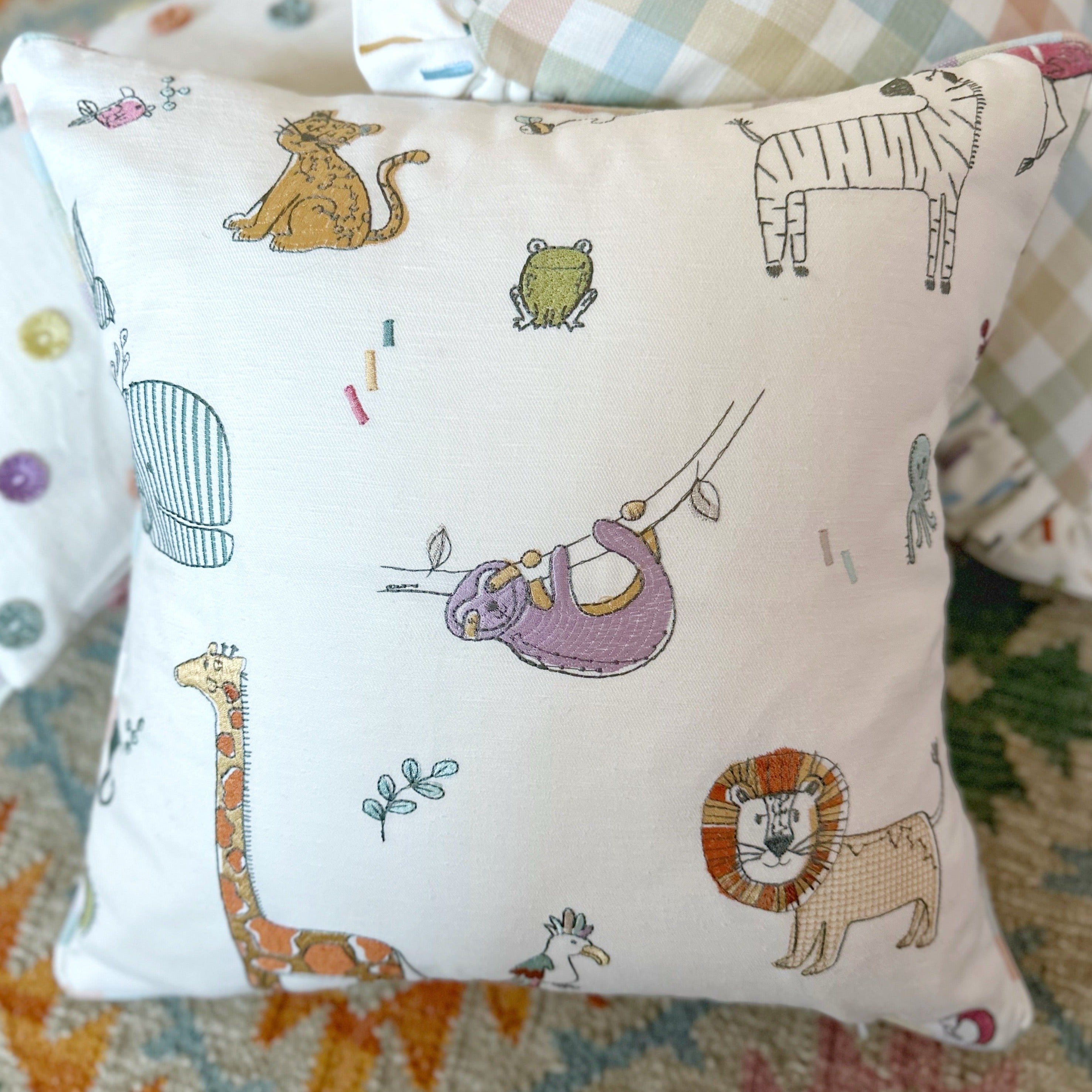 Embroidered animal cushion with stripe piping