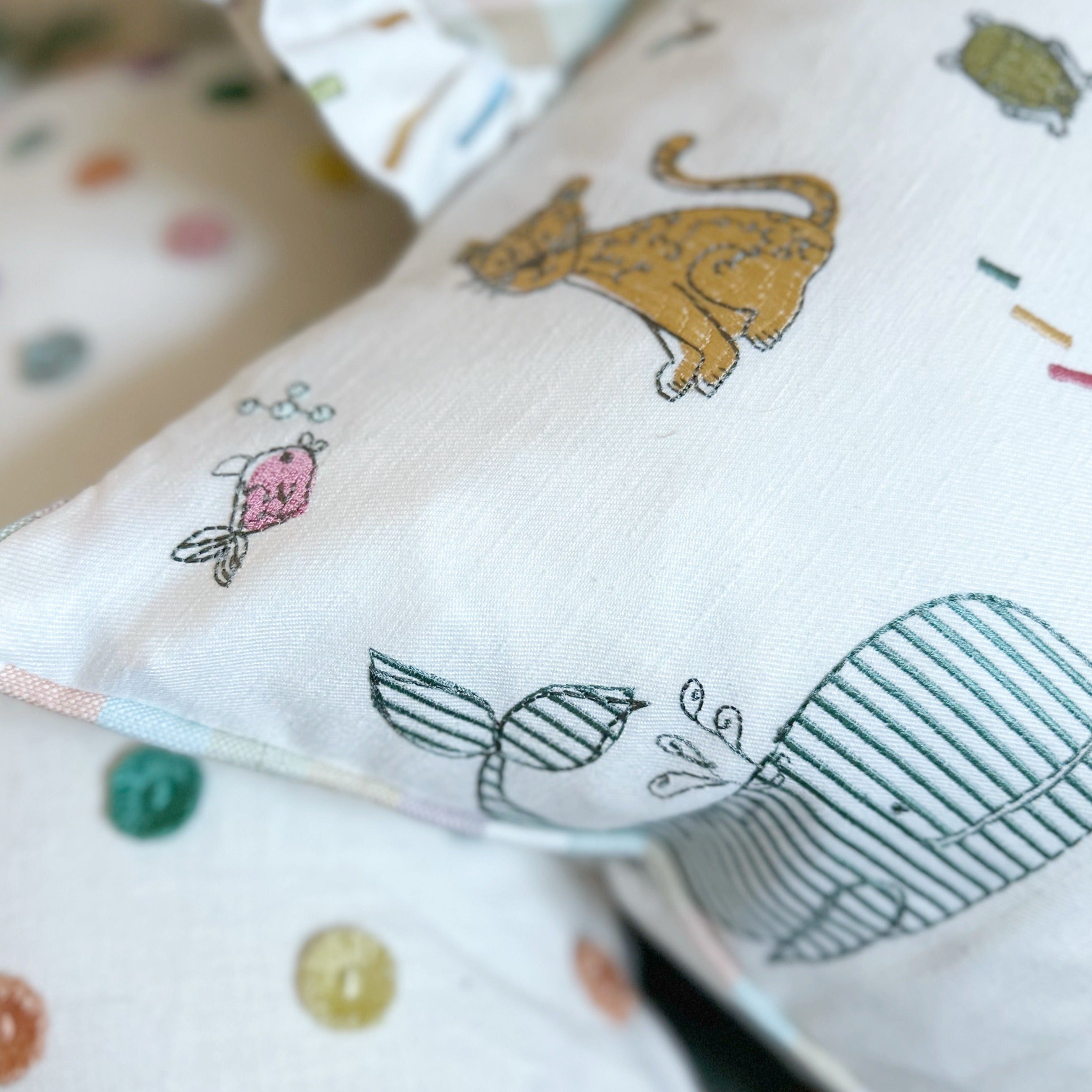 Embroidered animal cushion with stripe piping