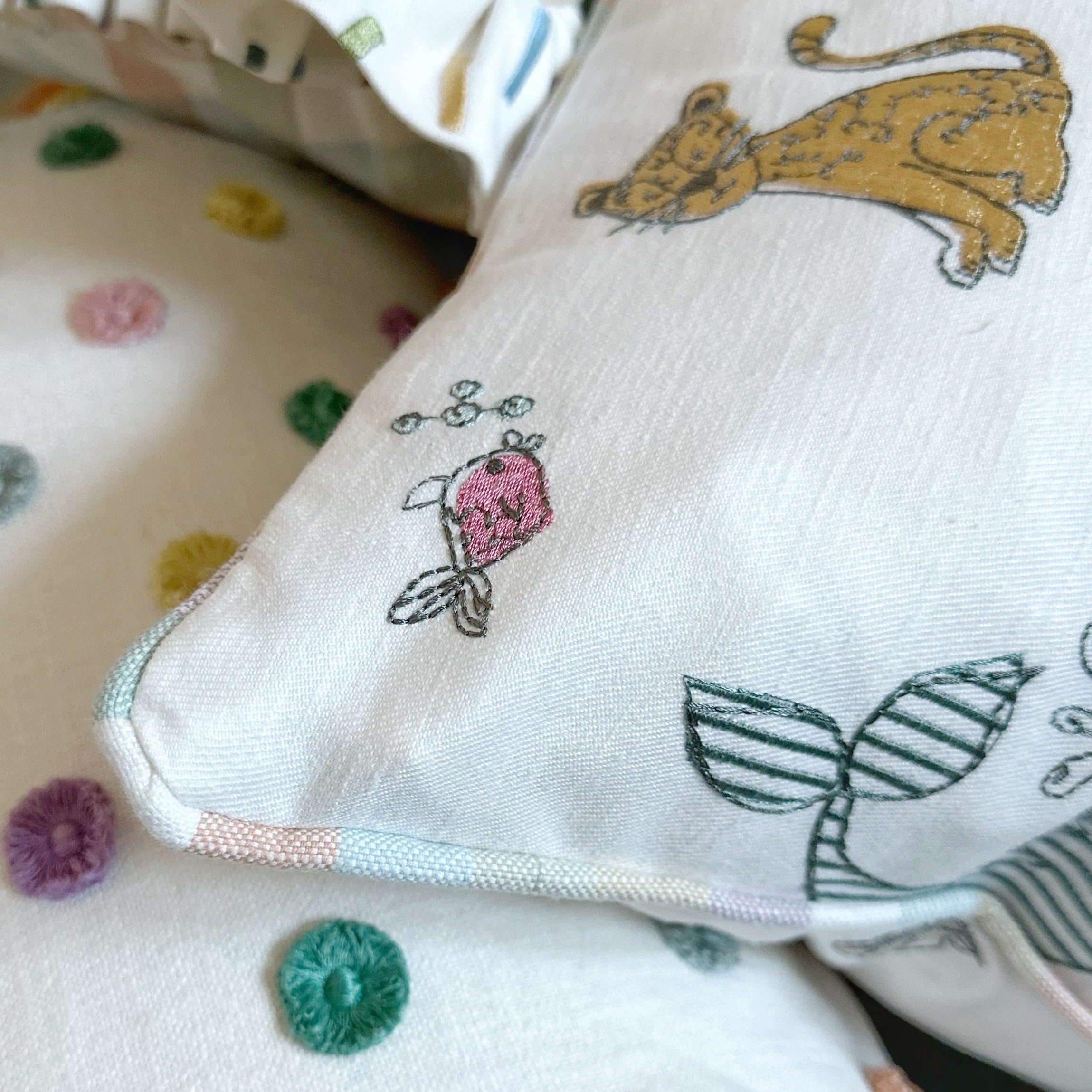 Embroidered animal cushion with stripe piping