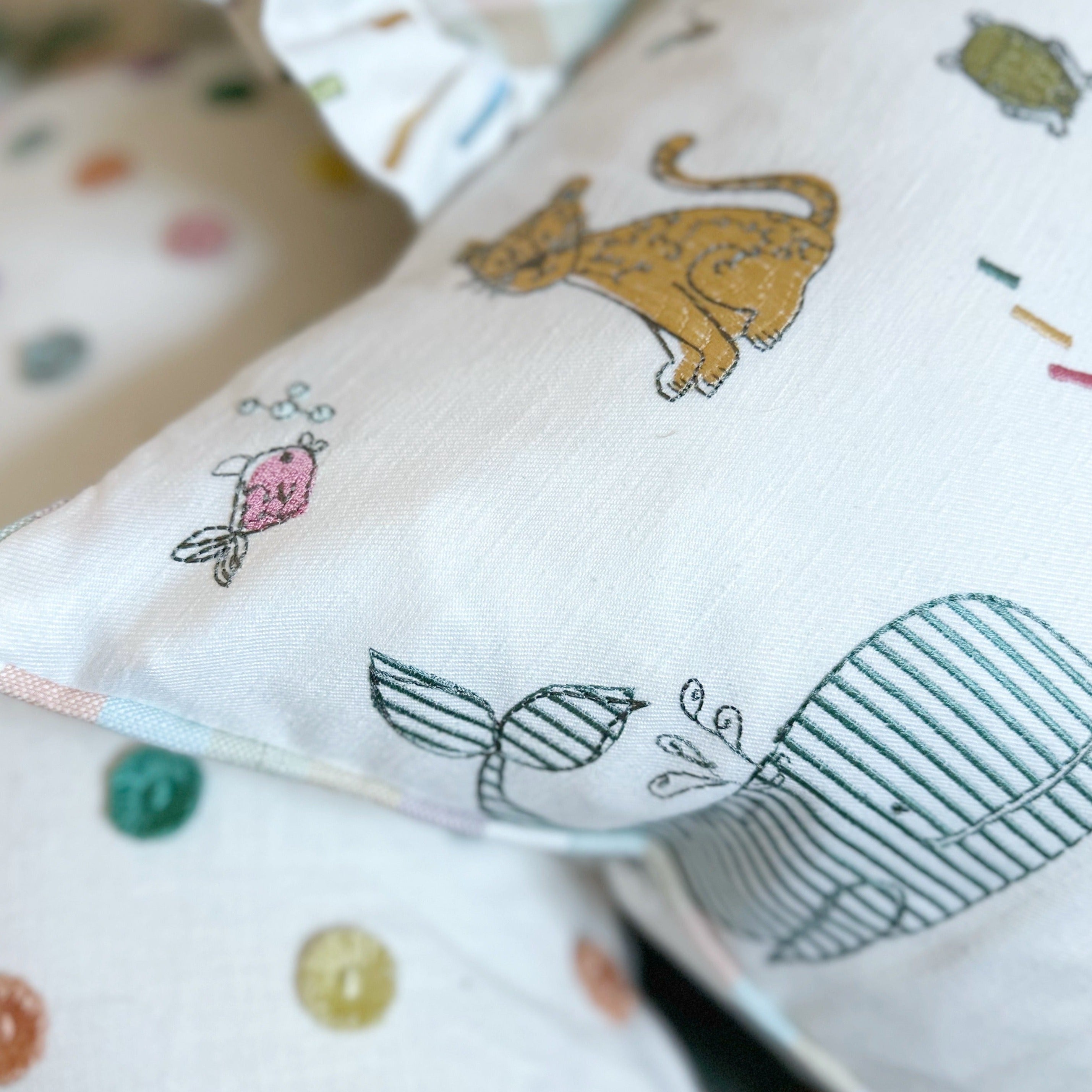Embroidered animal cushion cover with stripe piping